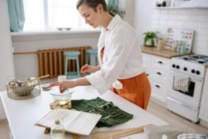 Woman Making Scented Candles on her Kitchen Table
